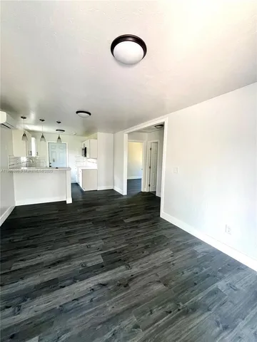 a view of kitchen and hall with wooden floor