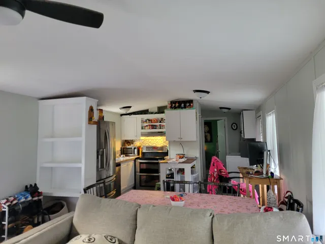 a room with furniture a flat screen tv and gym equipment