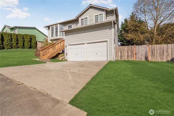 a front view of a house with a yard and garage