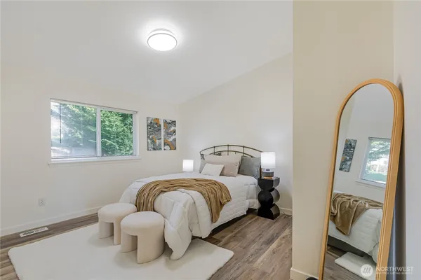 a bedroom with bed and a window