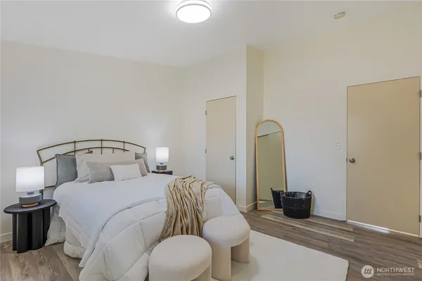 a bedroom with a bed and a mirror