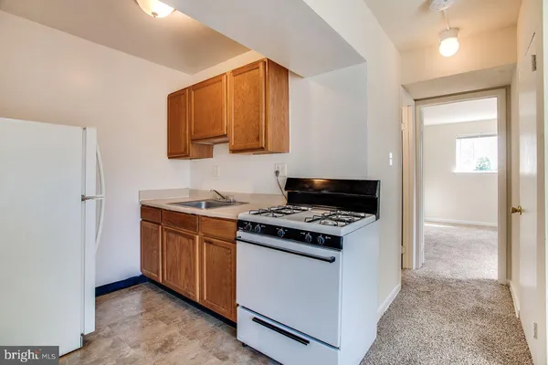 a kitchen with stainless steel appliances granite countertop a stove and a refrigerator