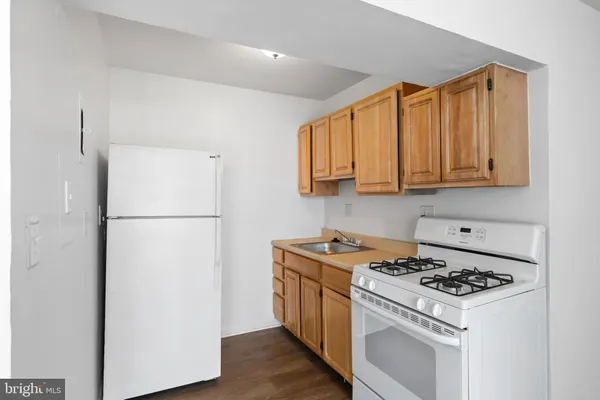 a kitchen with a stove a refrigerator and a sink