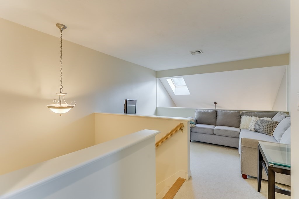 25 Rigsdale Way, Unit 25 Plymouth, MA 02360 - Photo 18 of 38 a living room with furniture and kitchen view