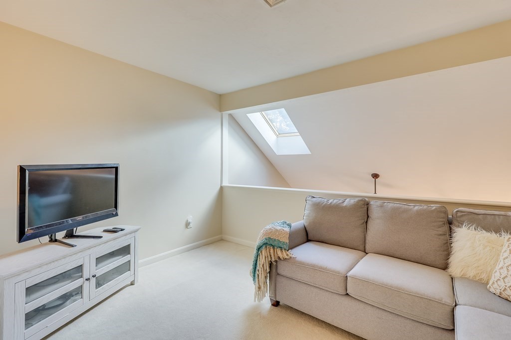 25 Rigsdale Way, Unit 25 Plymouth, MA 02360 - Photo 19 of 38 a living room with furniture and a flat screen tv