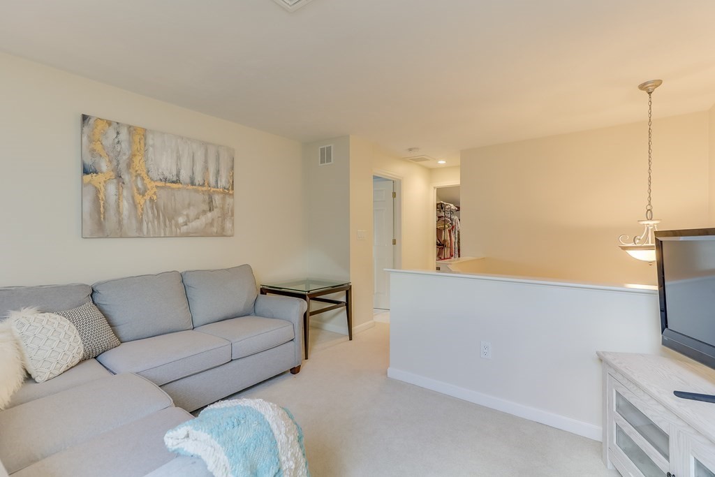 25 Rigsdale Way, Unit 25 Plymouth, MA 02360 - Photo 20 of 38 a living room with furniture and a flat screen tv