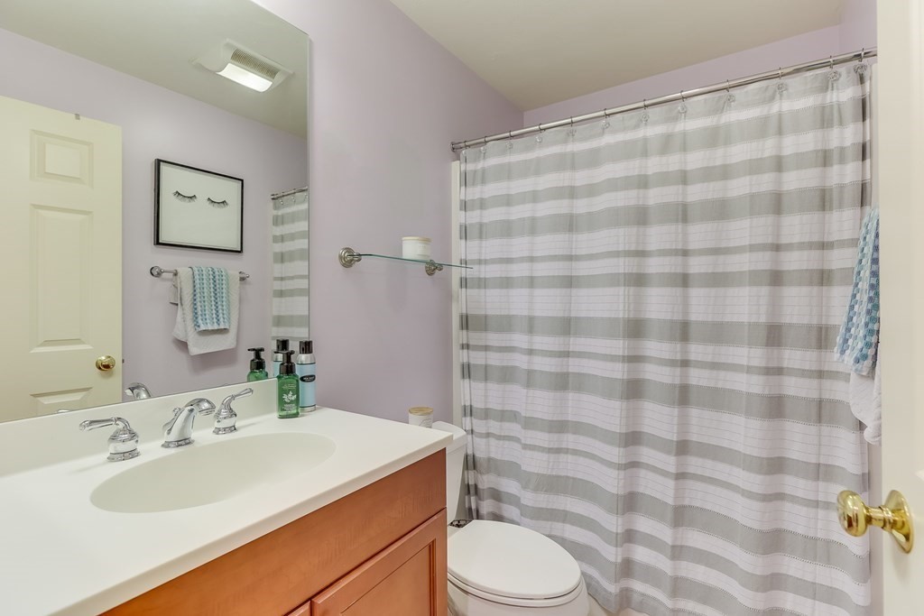 25 Rigsdale Way, Unit 25 Plymouth, MA 02360 - Photo 22 of 38 a bathroom with a sink a toilet and shower curtain