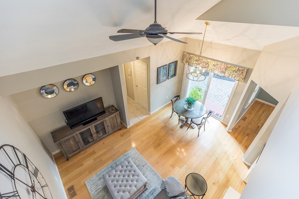 25 Rigsdale Way, Unit 25 Plymouth, MA 02360 - Photo 23 of 38 a dining room with wooden floor furniture and a chandelier