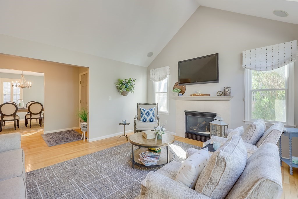 25 Rigsdale Way, Unit 25 Plymouth, MA 02360 - Photo 6 of 38 a living room with furniture a fireplace and a flat screen tv