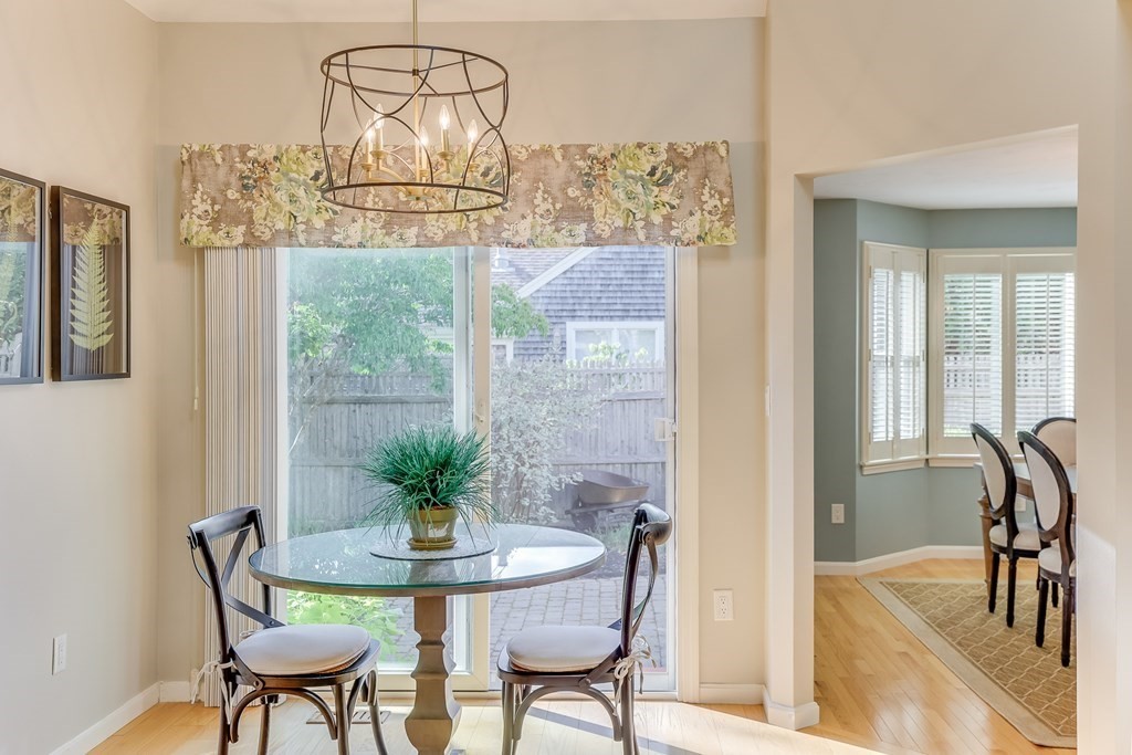 25 Rigsdale Way, Unit 25 Plymouth, MA 02360 - Photo 9 of 38 a view of a dining room with furniture a potted plant and a chandelier