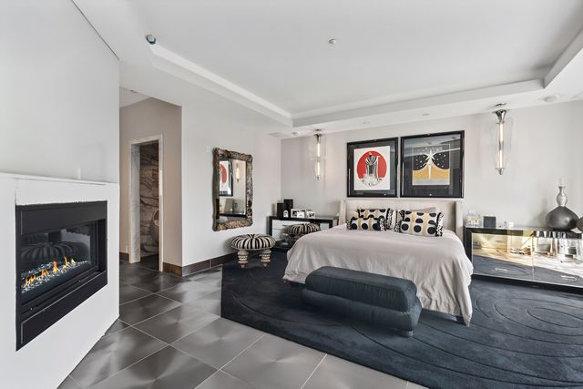 a bedroom with a bed and a fireplace