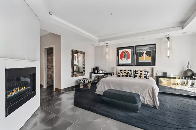 a bedroom with a bed and a fireplace