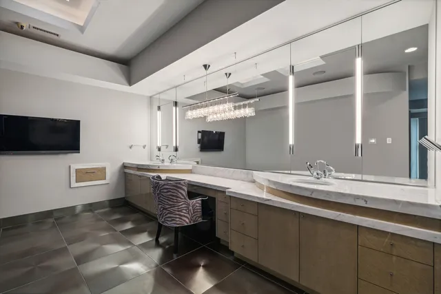 a bathroom with a granite countertop sink a mirror and a bathtub