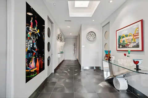 a view of an entryway with lots of frames on wall