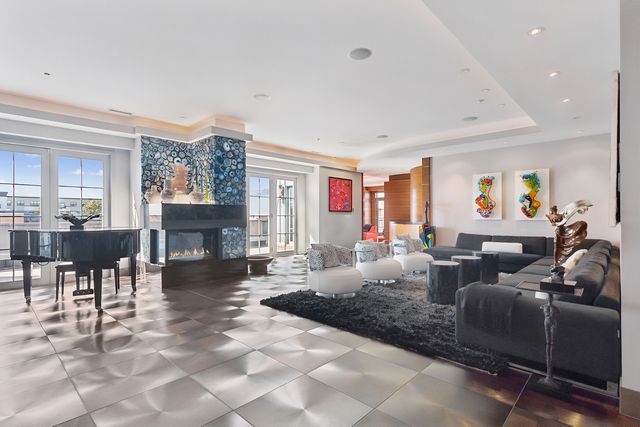 a living room with fireplace furniture and a fireplace