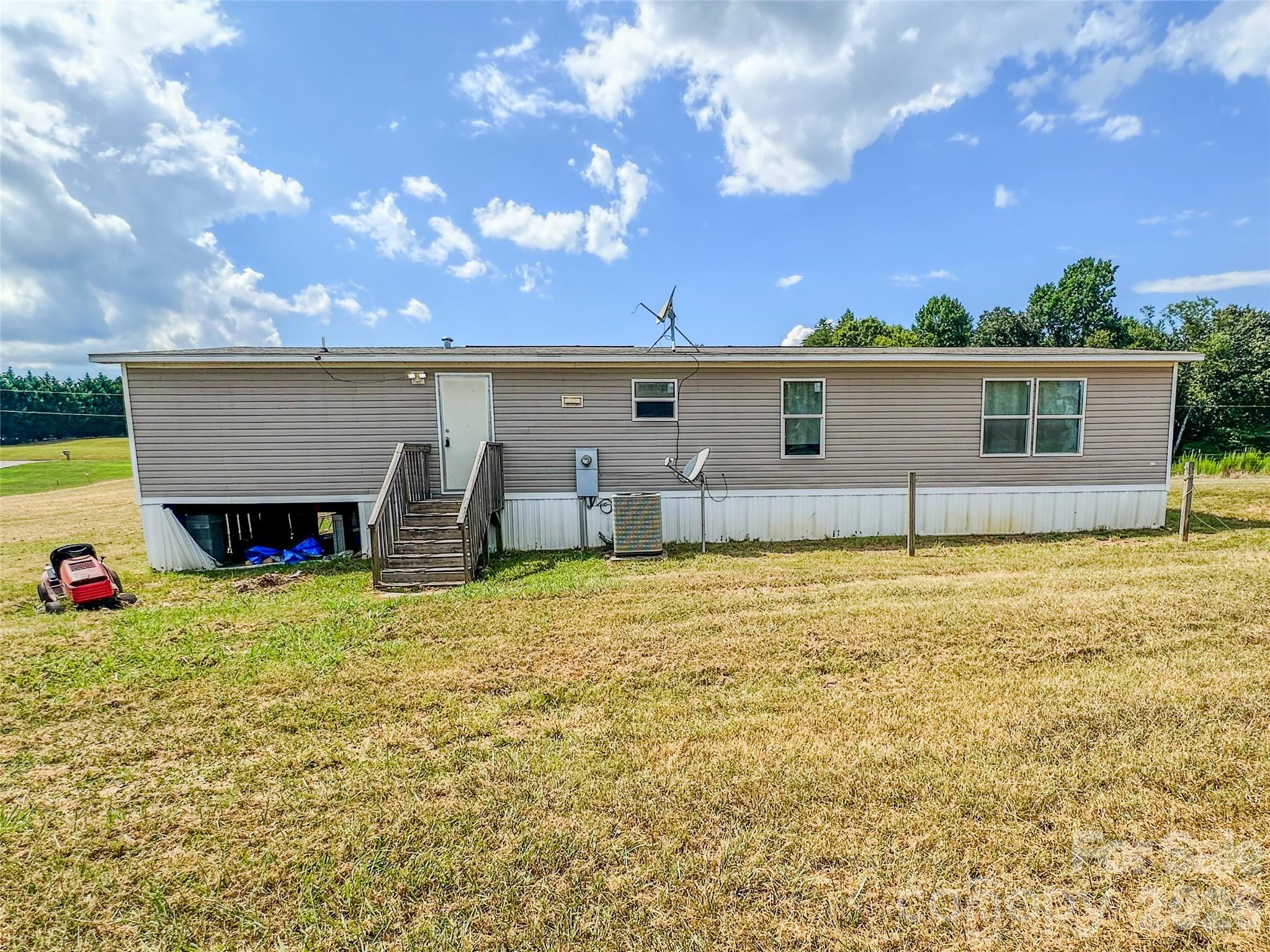 356 Brooks Road Bostic, NC 28018 - Photo 3 of 22 a backyard of a house with table and chairs