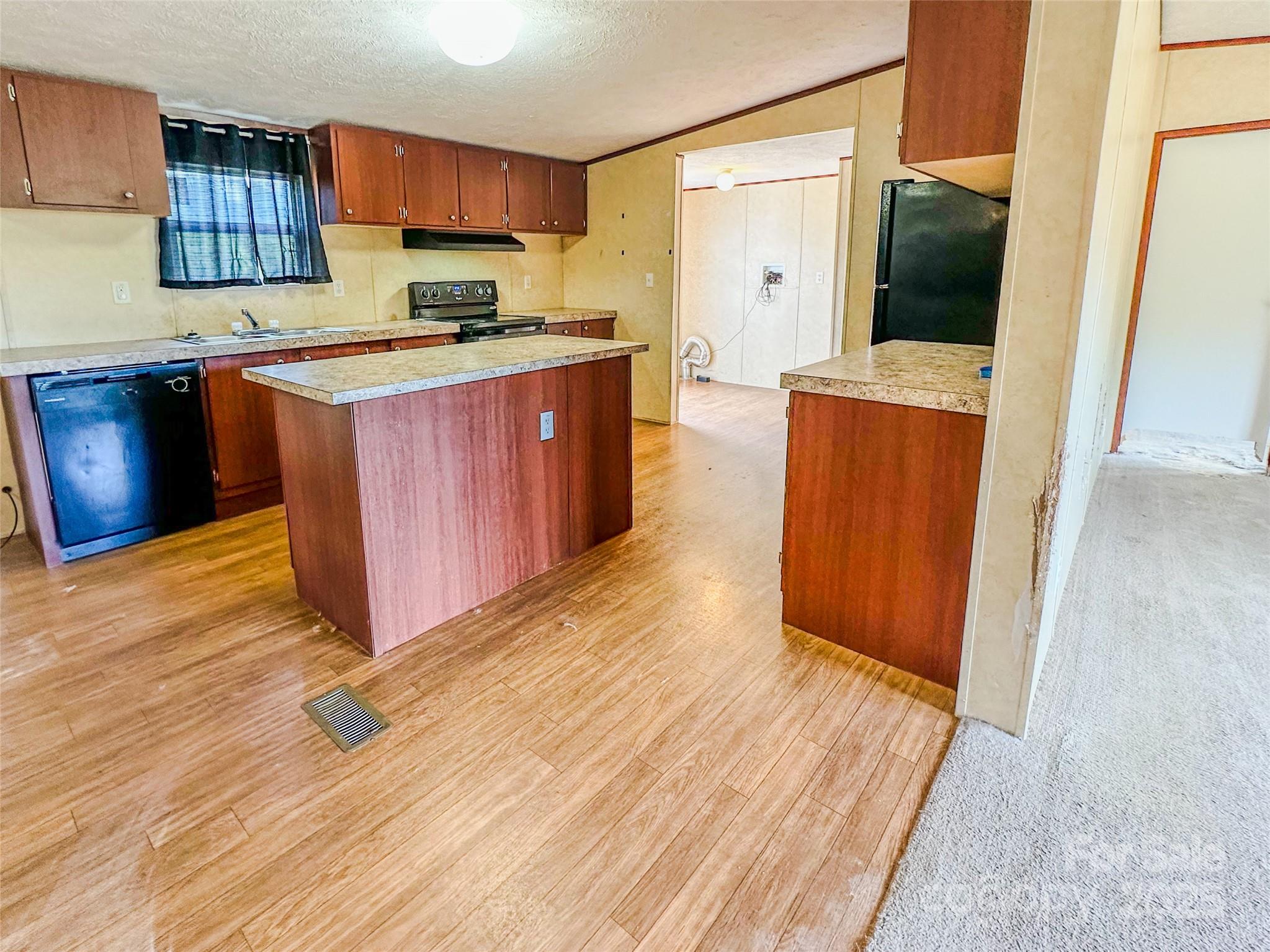 356 Brooks Road Bostic, NC 28018 - Photo 9 of 23 a kitchen with stainless steel appliances granite countertop a sink a stove top oven a refrigerator and cabinets