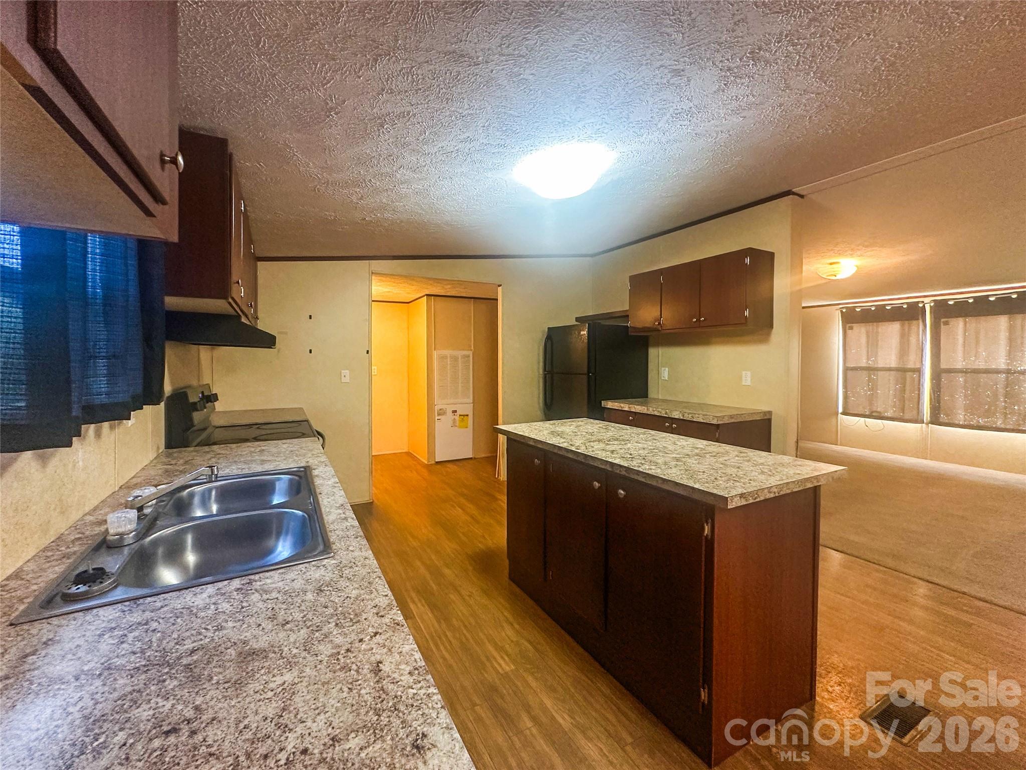 356 Brooks Road Bostic, NC 28018 - Photo 10 of 22 a kitchen with stainless steel appliances granite countertop a sink stove and refrigerator