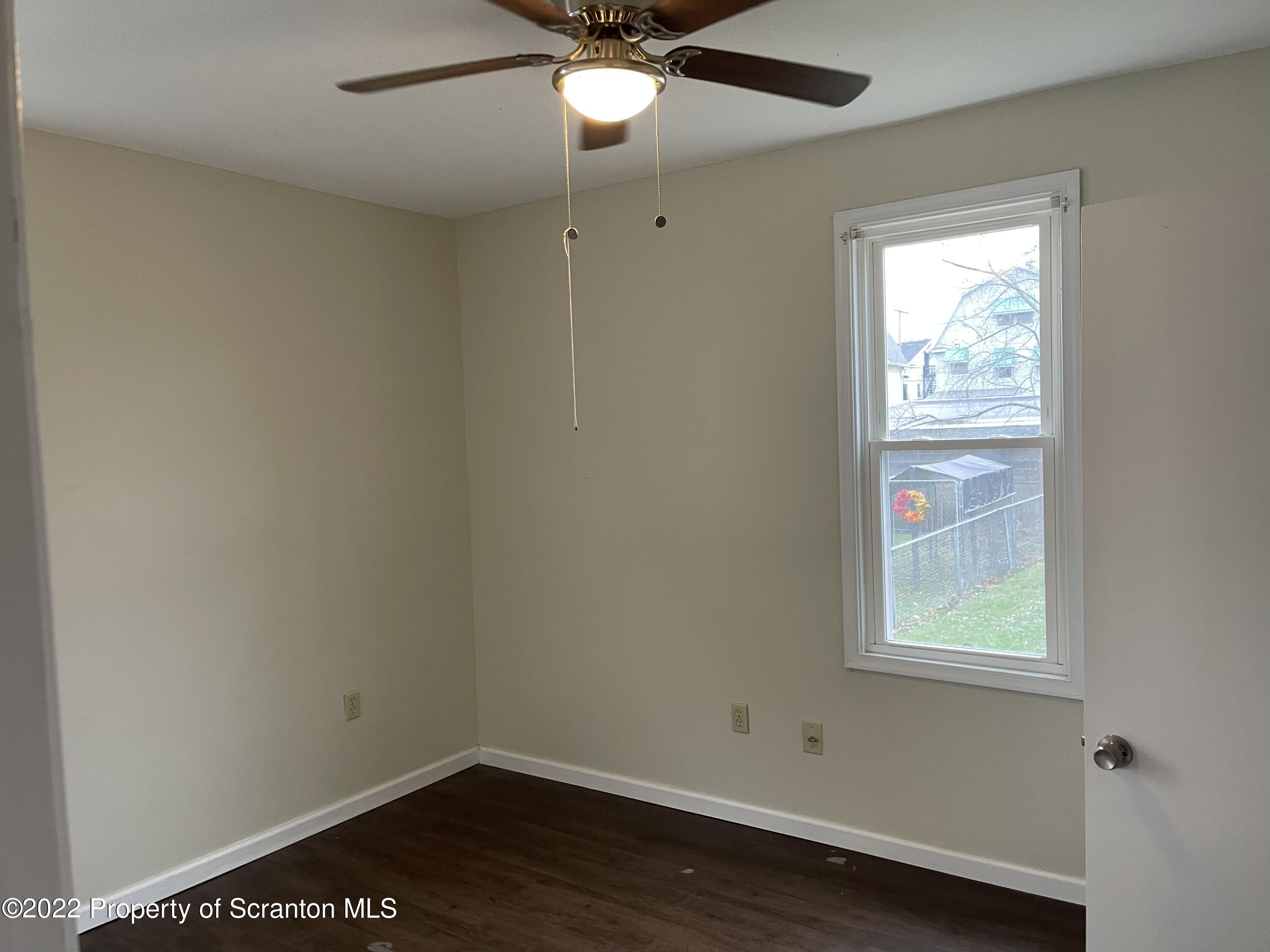 1012 Meade Street Scranton, PA 18512 - Photo 8 of 8 an empty room with a window and wooden floor