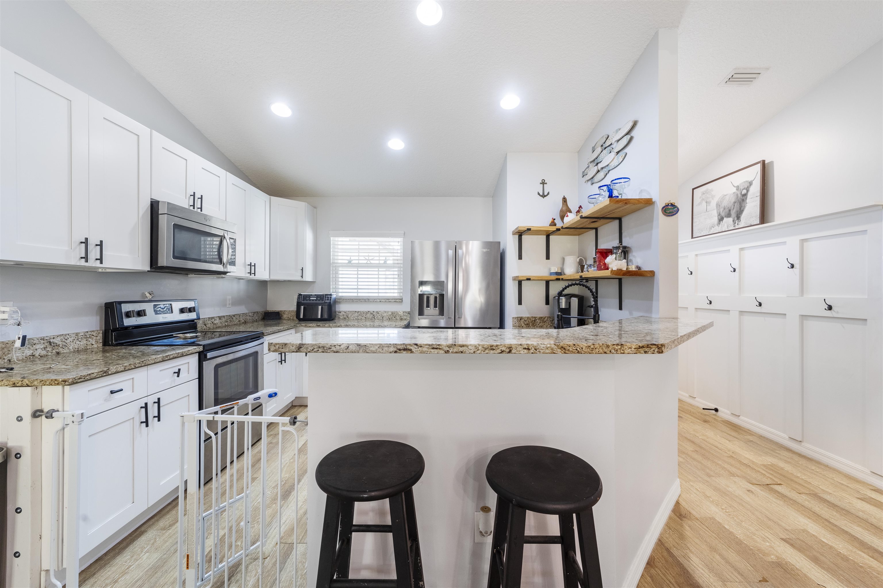 101 Azalea Road St. Augustine, FL 32086 - Photo 12 of 35 a kitchen with cabinets a sink and chairs in it