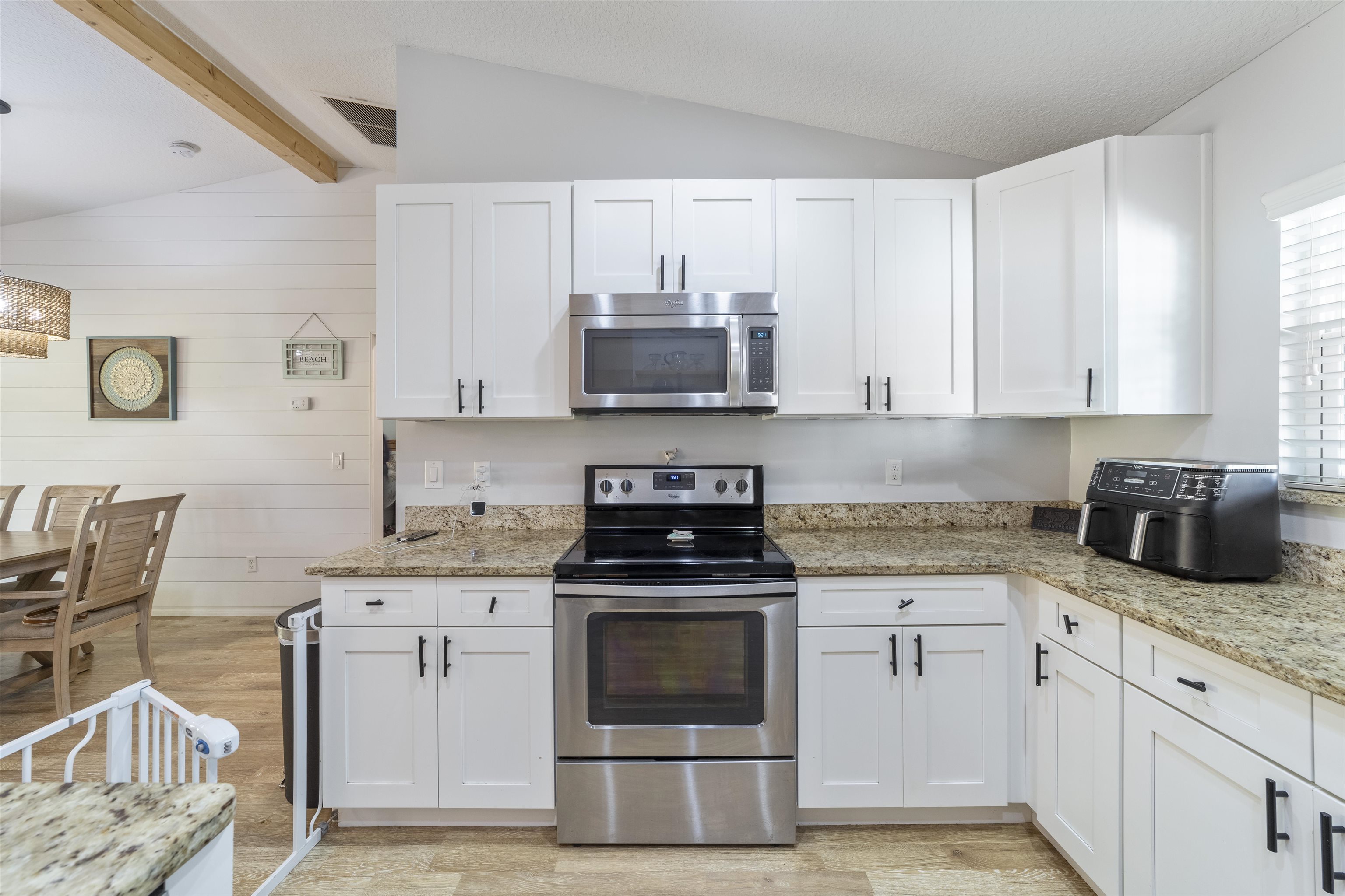 101 Azalea Road St. Augustine, FL 32086 - Photo 14 of 35 a kitchen with granite countertop a stove top oven a sink a counter space and cabinets