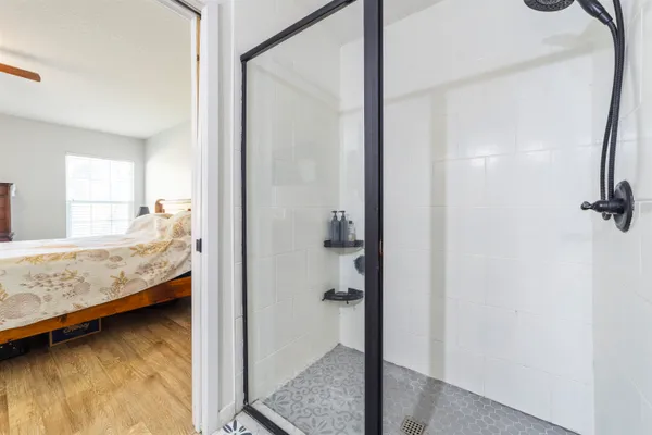 a bathroom with a tub and shower