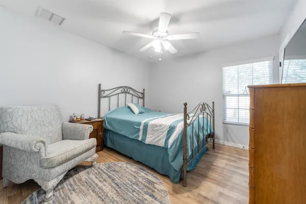 a bedroom with a bed couch and window