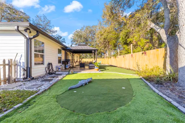 a swimming pool with outdoor seating and yard