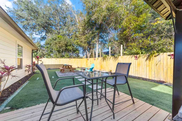 a view of a chairs and table in patio with a yard