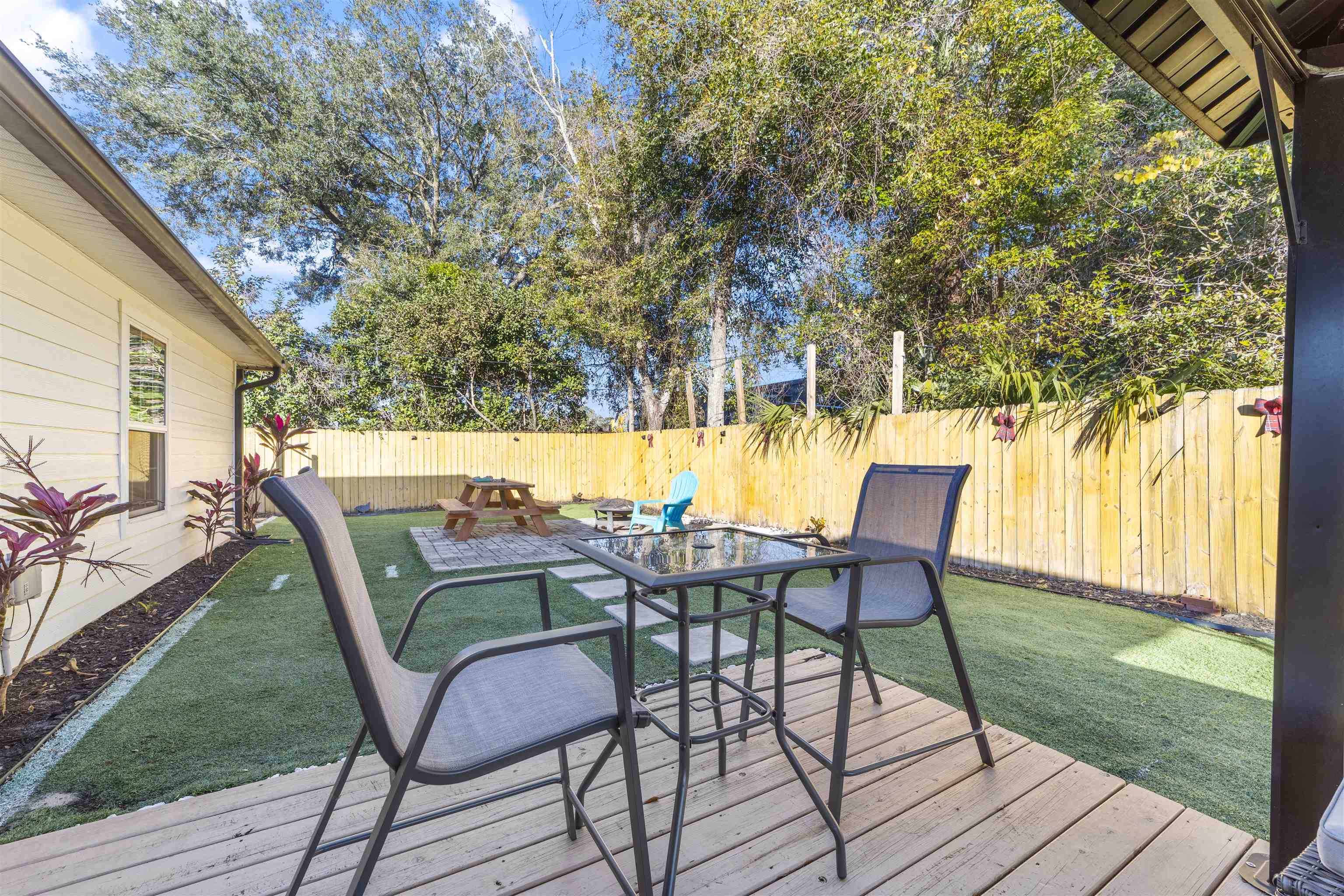 101 Azalea Road St. Augustine, FL 32086 - Photo 30 of 35 a view of a chairs and table in patio with a yard