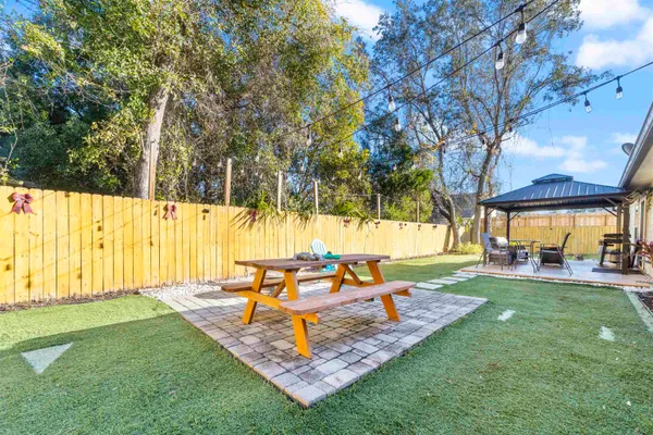 a view of a backyard with sitting area