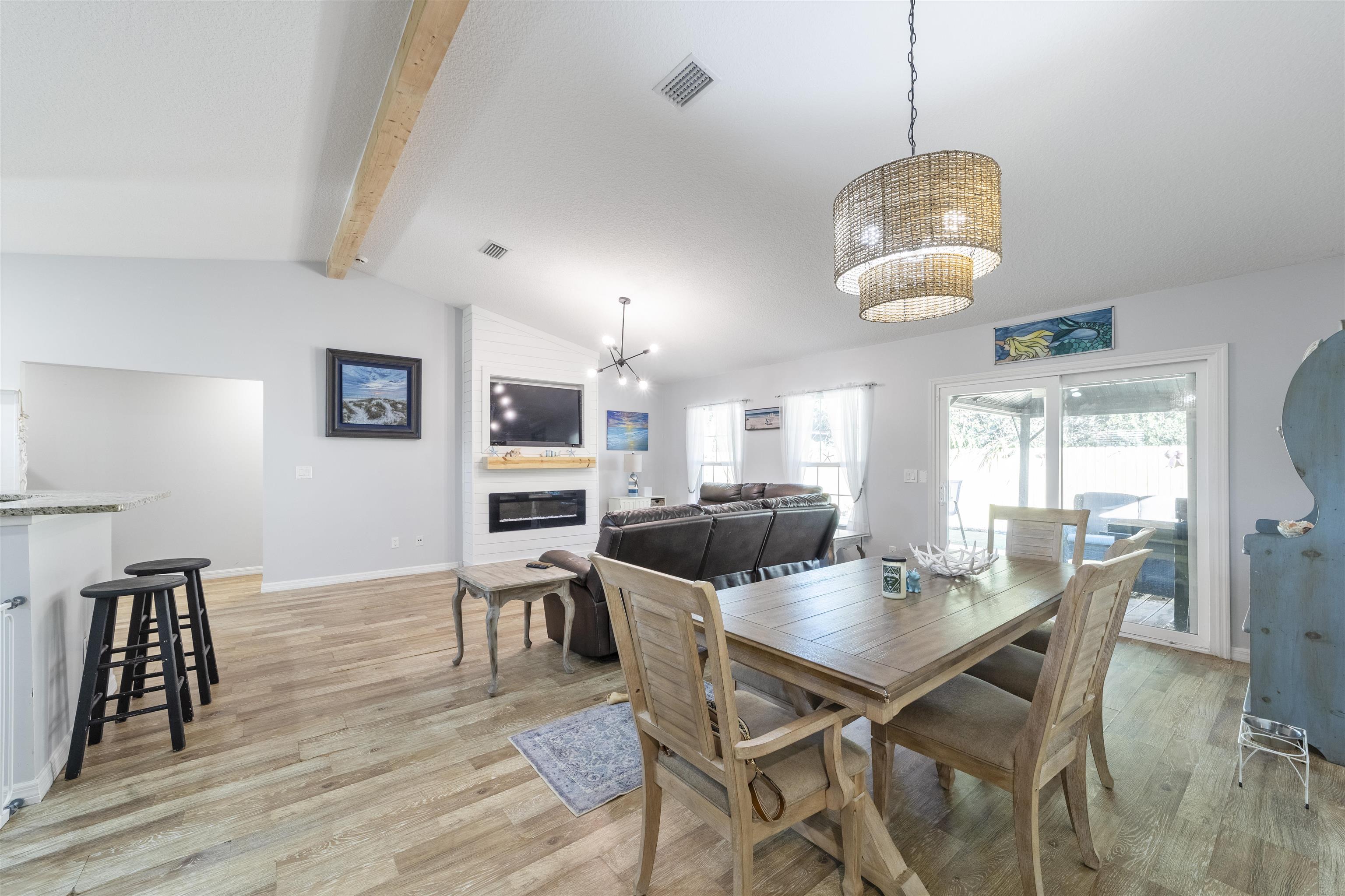 101 Azalea Road St. Augustine, FL 32086 - Photo 7 of 35 a view of a dining room with furniture a chandelier and wooden floor