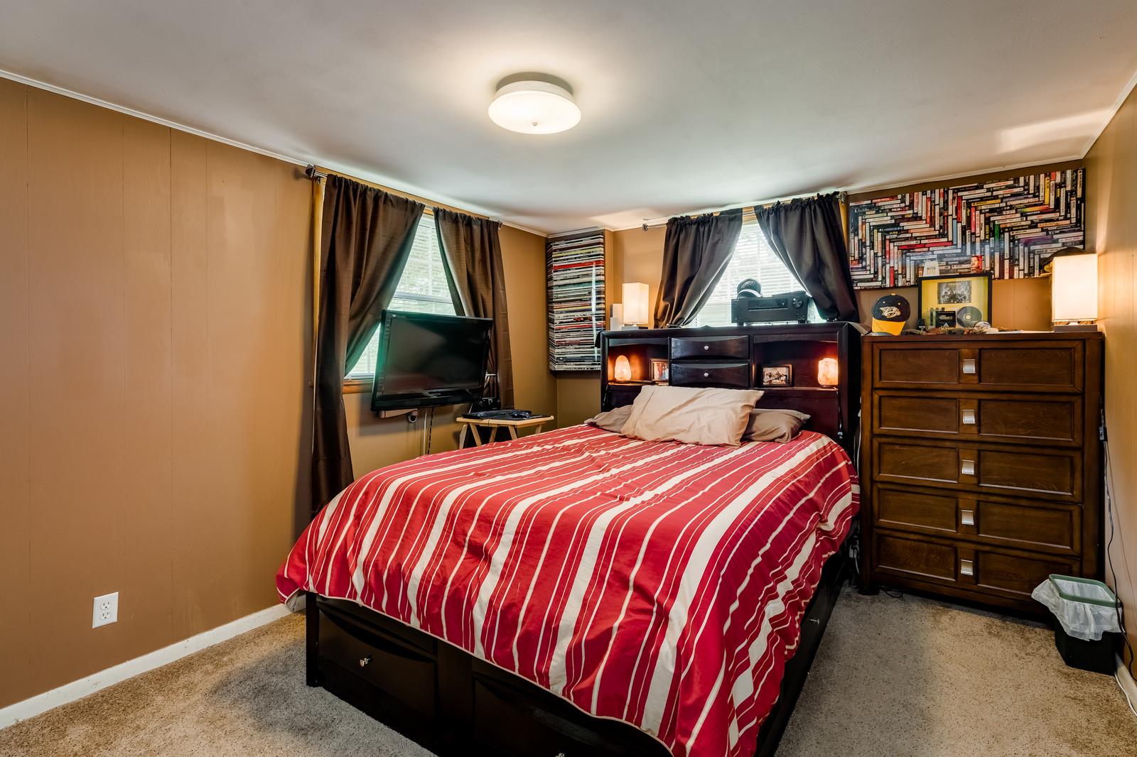 1036 Neelys Bend Road Madison, TN 37115 - Photo 17 of 29 a bedroom with a bed and a window