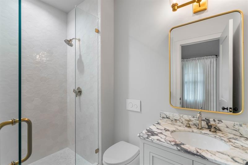 1026 Reeder Circle Northeast Atlanta, GA 30306 - Photo 47 of 95 a bathroom with a granite countertop sink toilet and shower