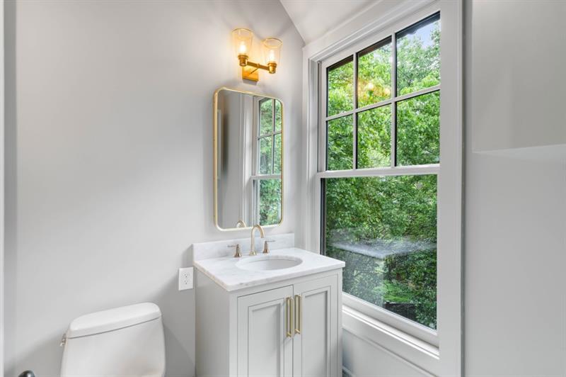 1026 Reeder Circle Northeast Atlanta, GA 30306 - Photo 50 of 95 a bathroom with a sink a toilet and a window