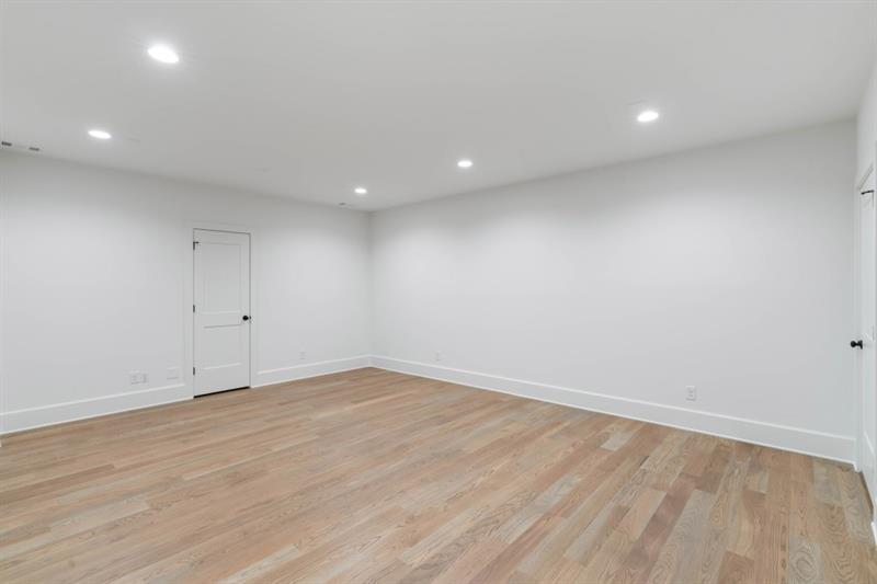 1026 Reeder Circle Northeast Atlanta, GA 30306 - Photo 60 of 95 an empty room with wooden floor and white walls