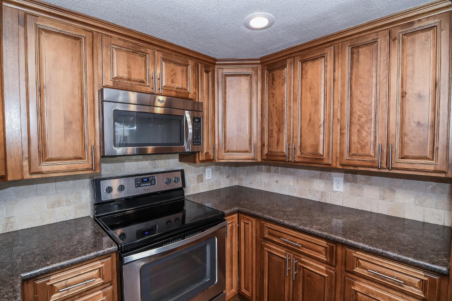 1139 Rivara Circle Sacramento, CA 95864 - Photo 24 of 72 a kitchen with wooden cabinets and a stove top oven