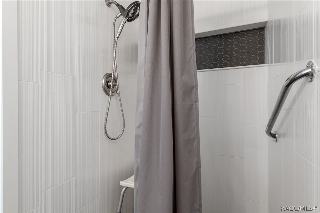 1140 South Highlands Avenue Inverness, FL 34452 - Photo 25 of 54 a bathroom with a glass shower door