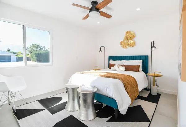 a bedroom with a bed and window