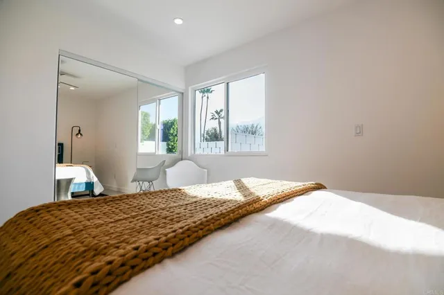 a bedroom with a bed and a window