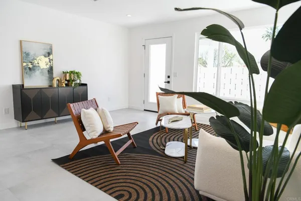 a living room with furniture and a floor to ceiling window
