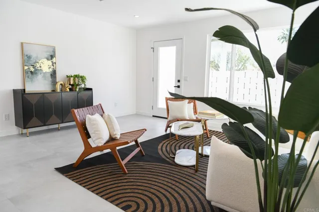a living room with furniture and a floor to ceiling window
