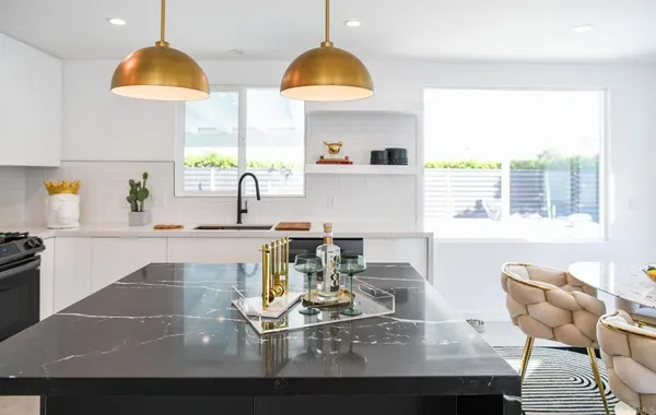 a kitchen with a sink dining table and chairs