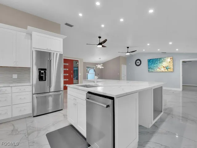 a kitchen with a sink stainless steel appliances and cabinets