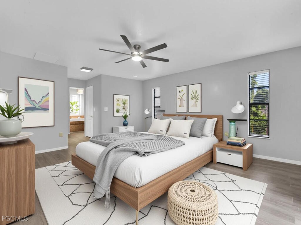 11981 Plantation Road Fort Myers, FL 33966 - Photo 15 of 48 a spacious bedroom with a bed a mirror and a window