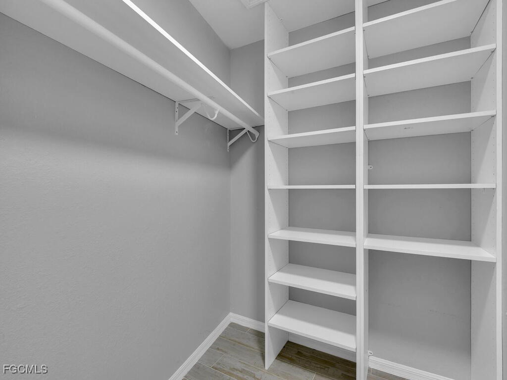 11981 Plantation Road Fort Myers, FL 33966 - Photo 19 of 48 a view of an empty walk in closet