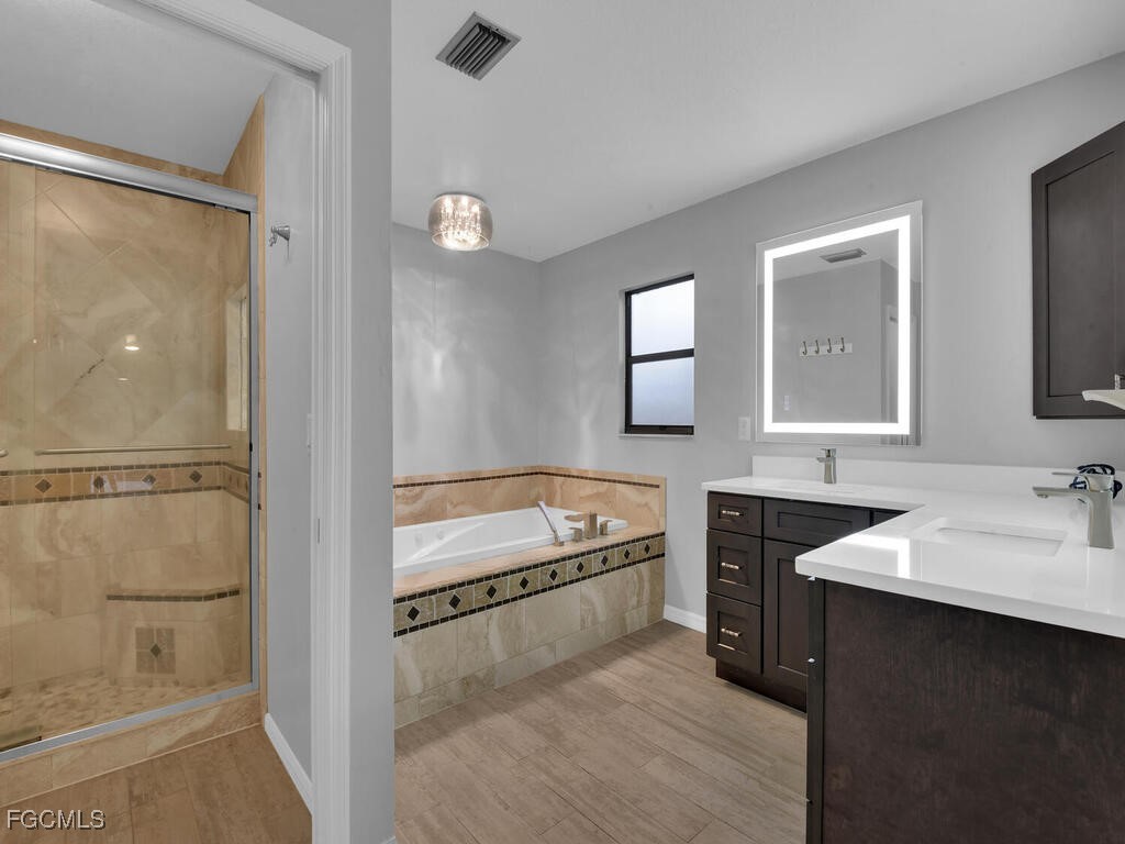 11981 Plantation Road Fort Myers, FL 33966 - Photo 20 of 48 a bathroom with a tub sink and mirror