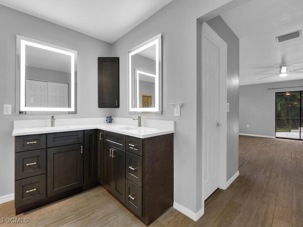11981 Plantation Road Fort Myers, FL 33966 - Photo 21 of 48 a bathroom with a sink vanity and mirror