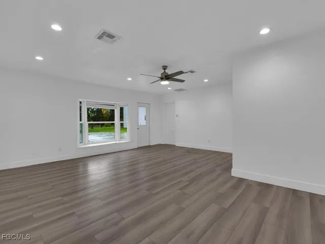 wooden floor in an empty room with a window