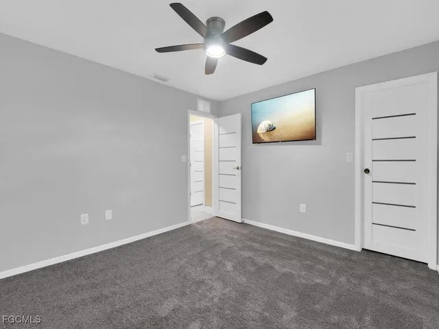 a view of an empty room and closet area